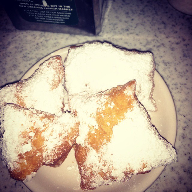 powdered sugar is covering the pastries on a plate