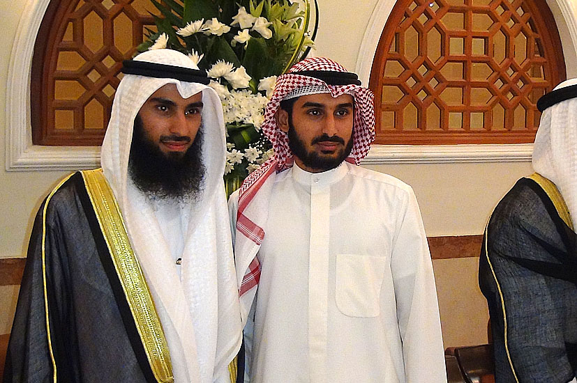 two men with beards and headgear pose for a picture