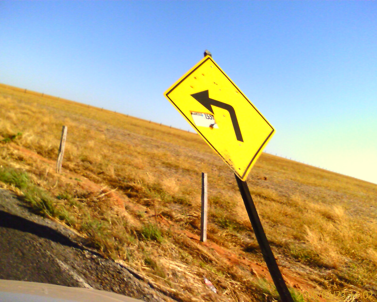 a street sign on a dry grassy plain
