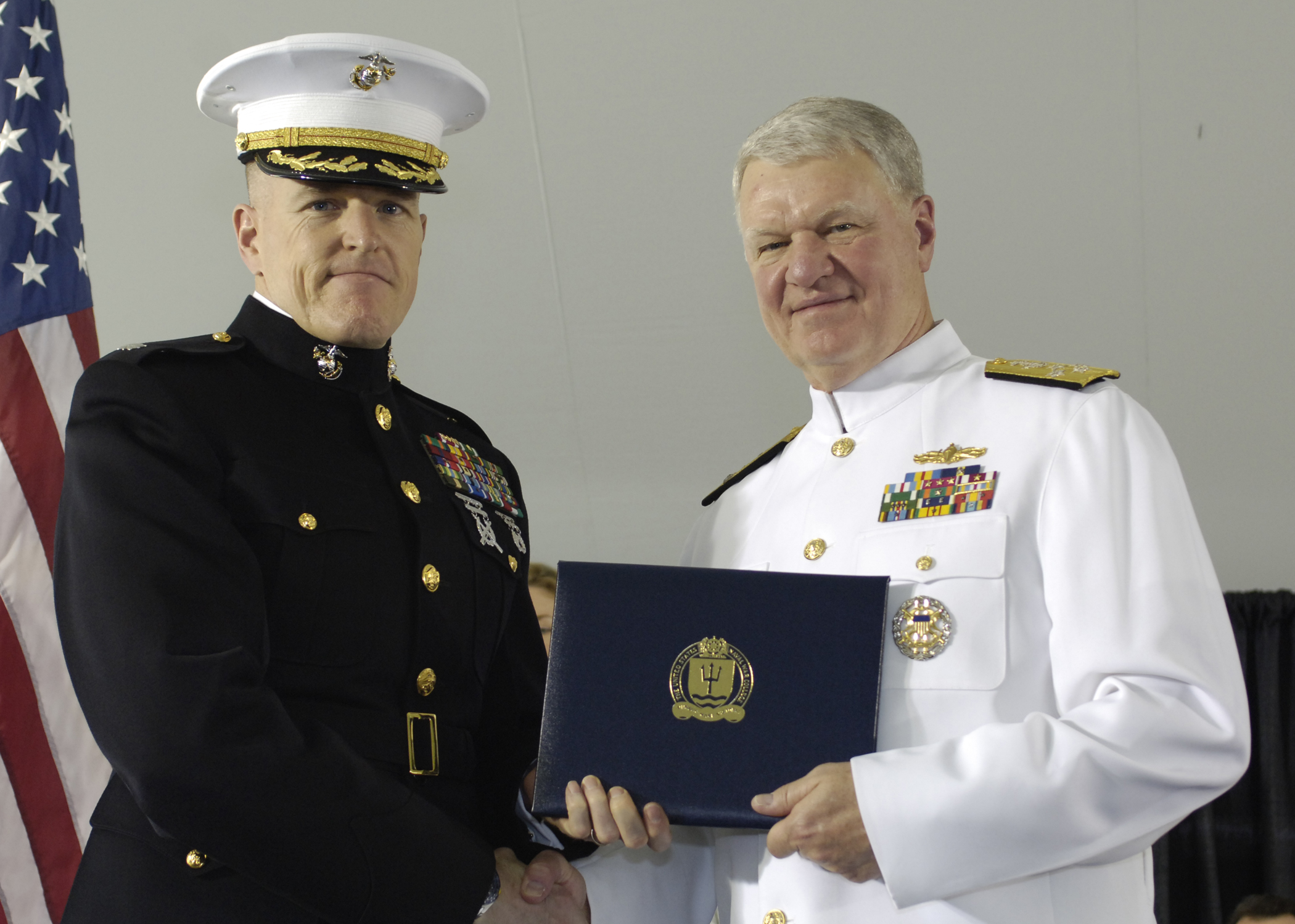 a man in uniform is holding an award