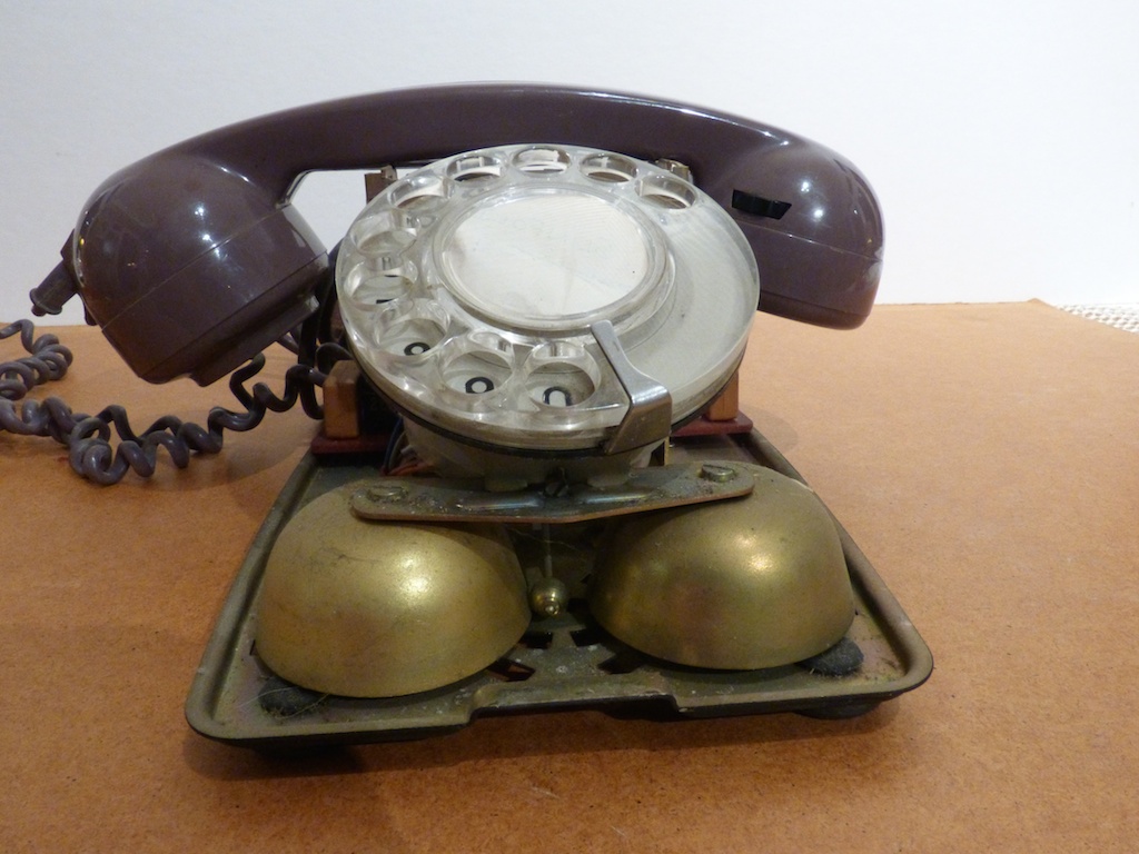 a close up of an old style telephone on a table