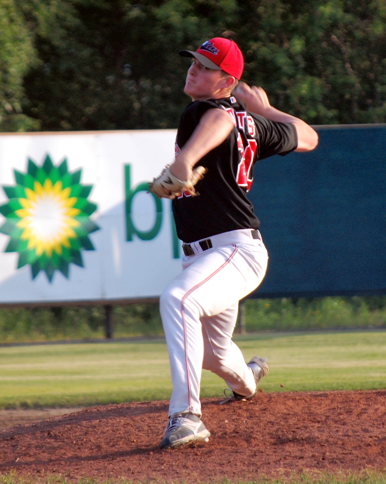 a man throwing a baseball in a field