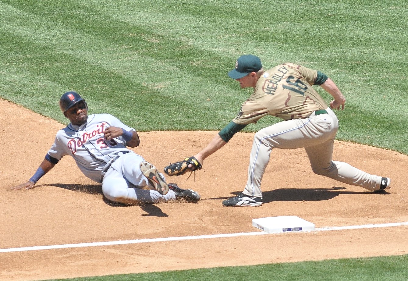 a couple of baseball players playing baseball on a field