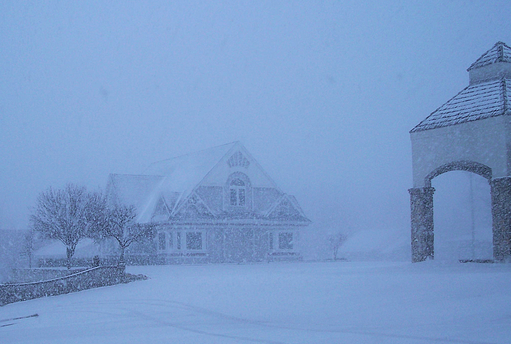 a house is shown with the clock tower in the snow