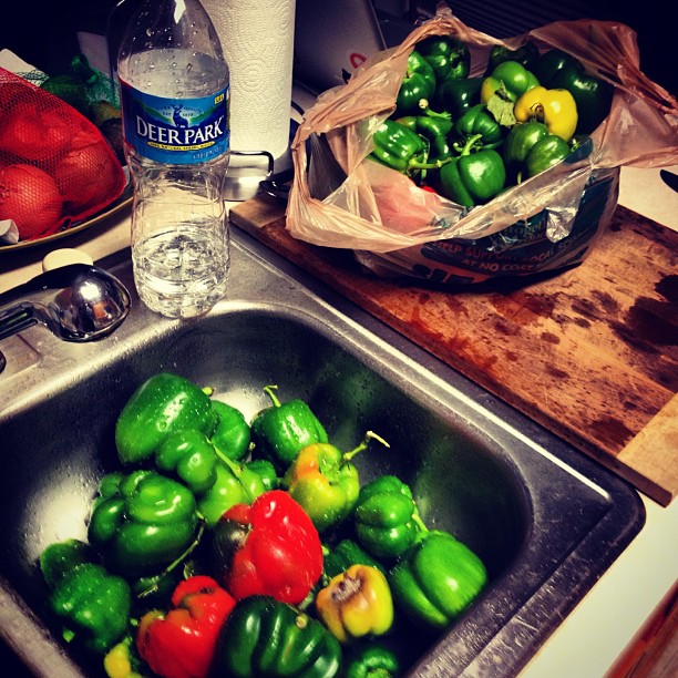 peppers are in a bowl on the kitchen sink