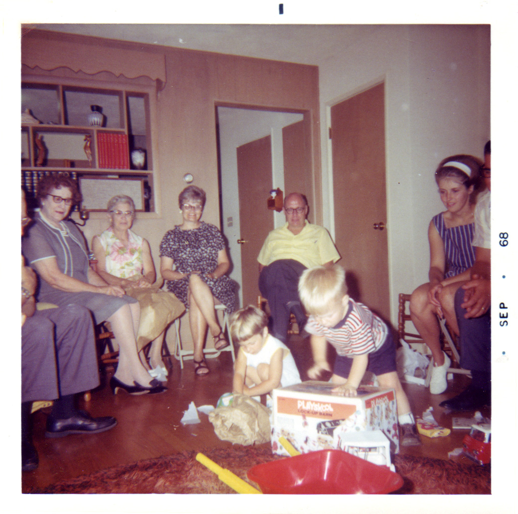 a group of people with a child playing with a toy