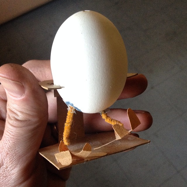 an egg sitting on top of a piece of cardboard