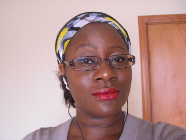 a woman with glasses wearing a head scarf