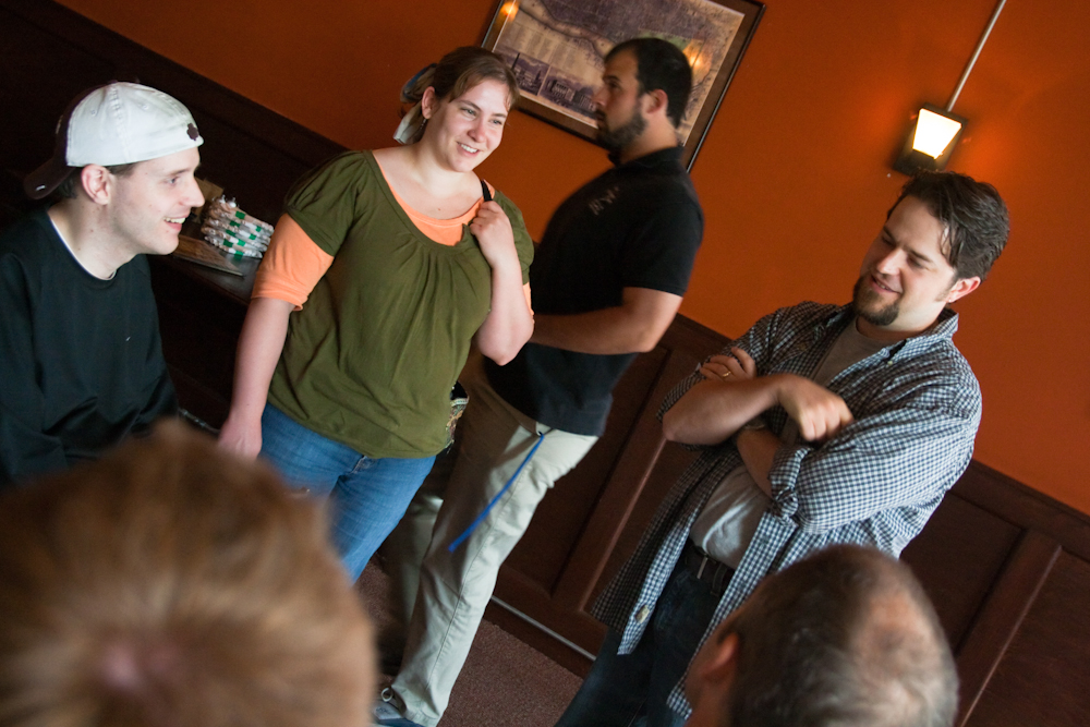 group of people standing in front of door looking at soing