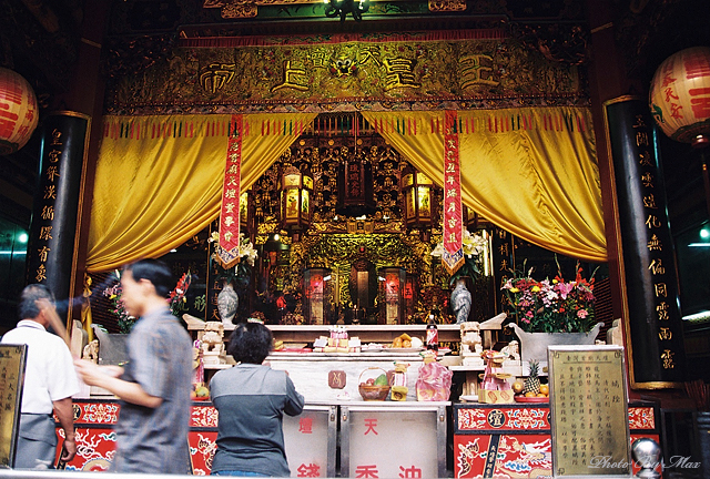 two people stand at the counter in an oriental temple