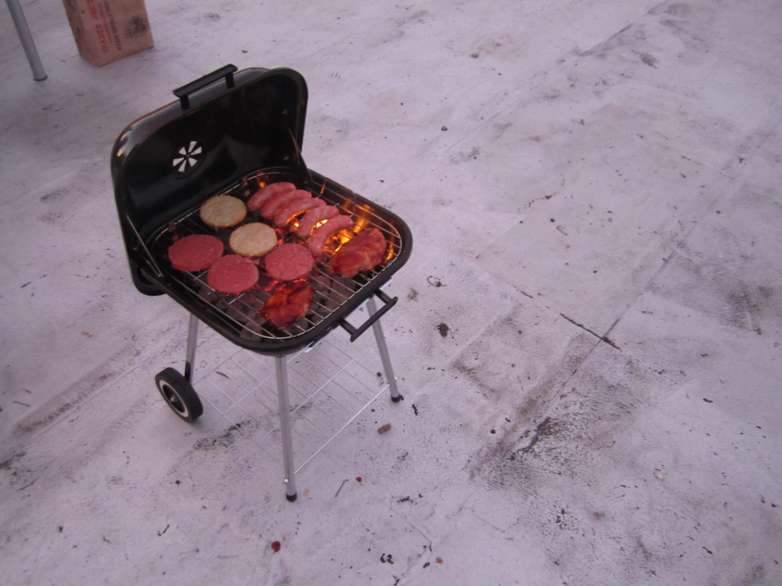 a grill top with hamburgers on a dolly