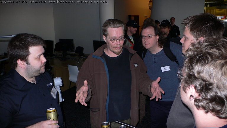 several people standing and talking in an office