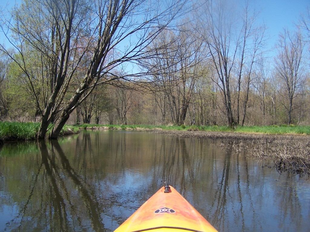 a yellow kayak is going through a body of water