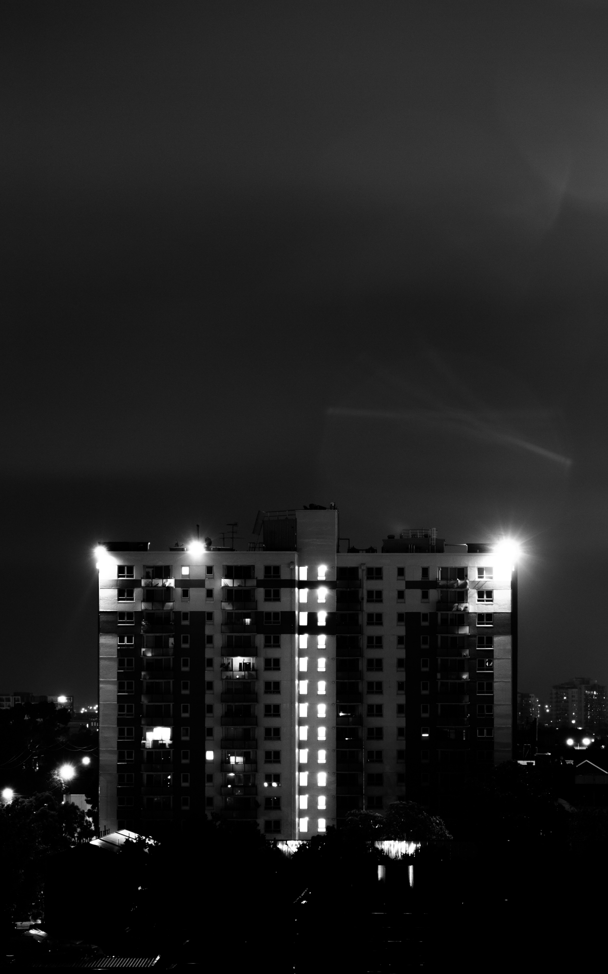 an apartment building at night with the lights on