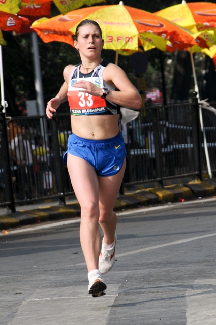 a girl running wearing shorts and a sports 