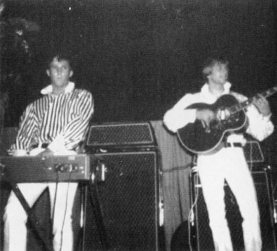 a black and white po shows two men in the microphone playing music