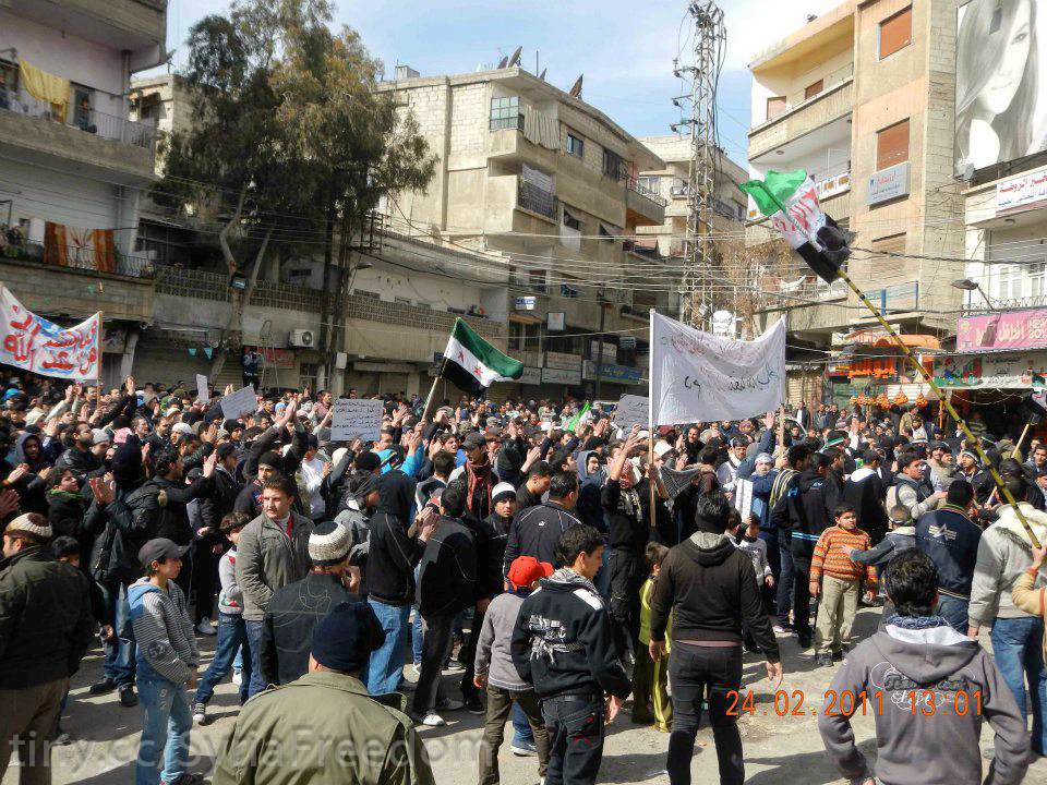 large group of people with banner and flag in street area