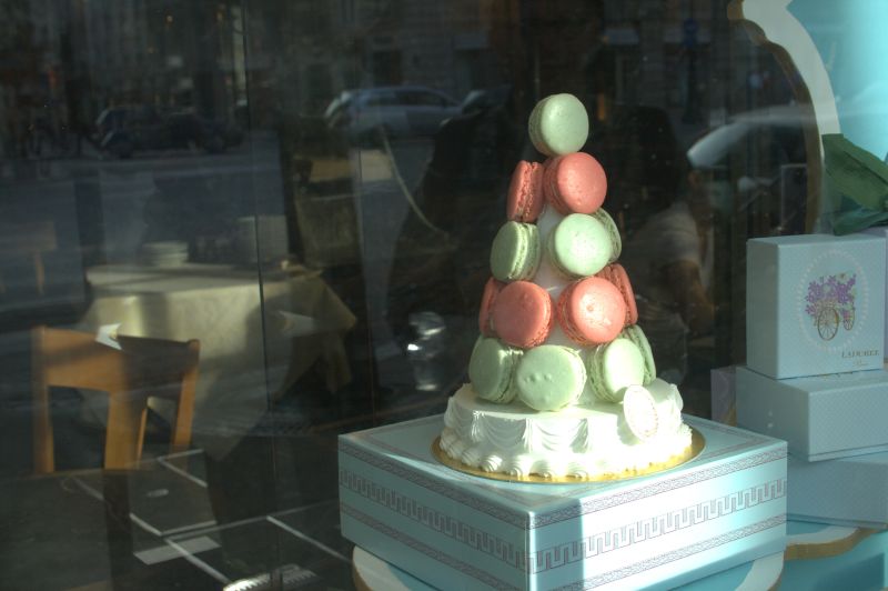 there is a small cake on display outside a window