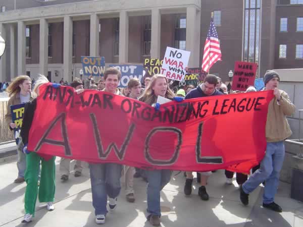 a group of people with some holding a red sign