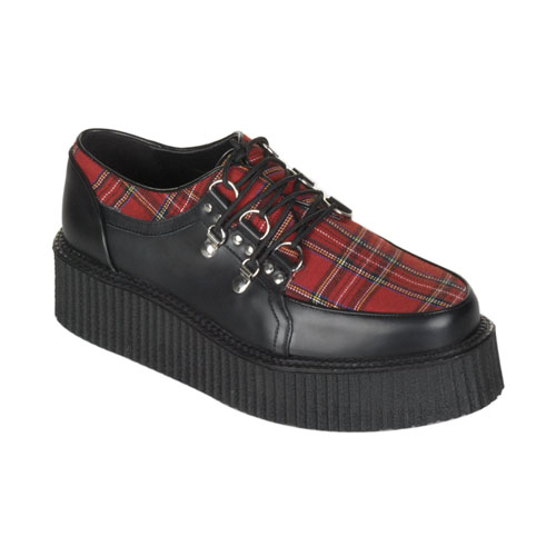 a woman is wearing black and red plaid shoes