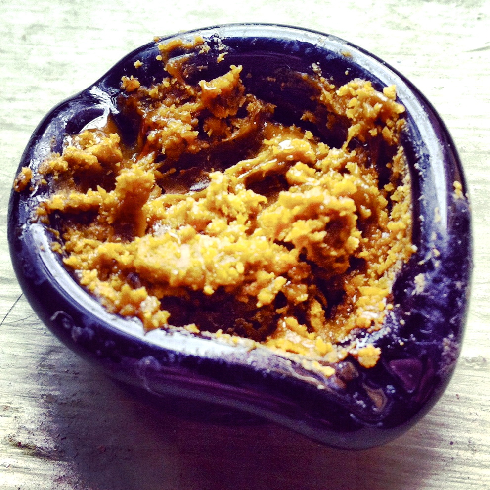 a small purple and yellow colored object on top of wooden table