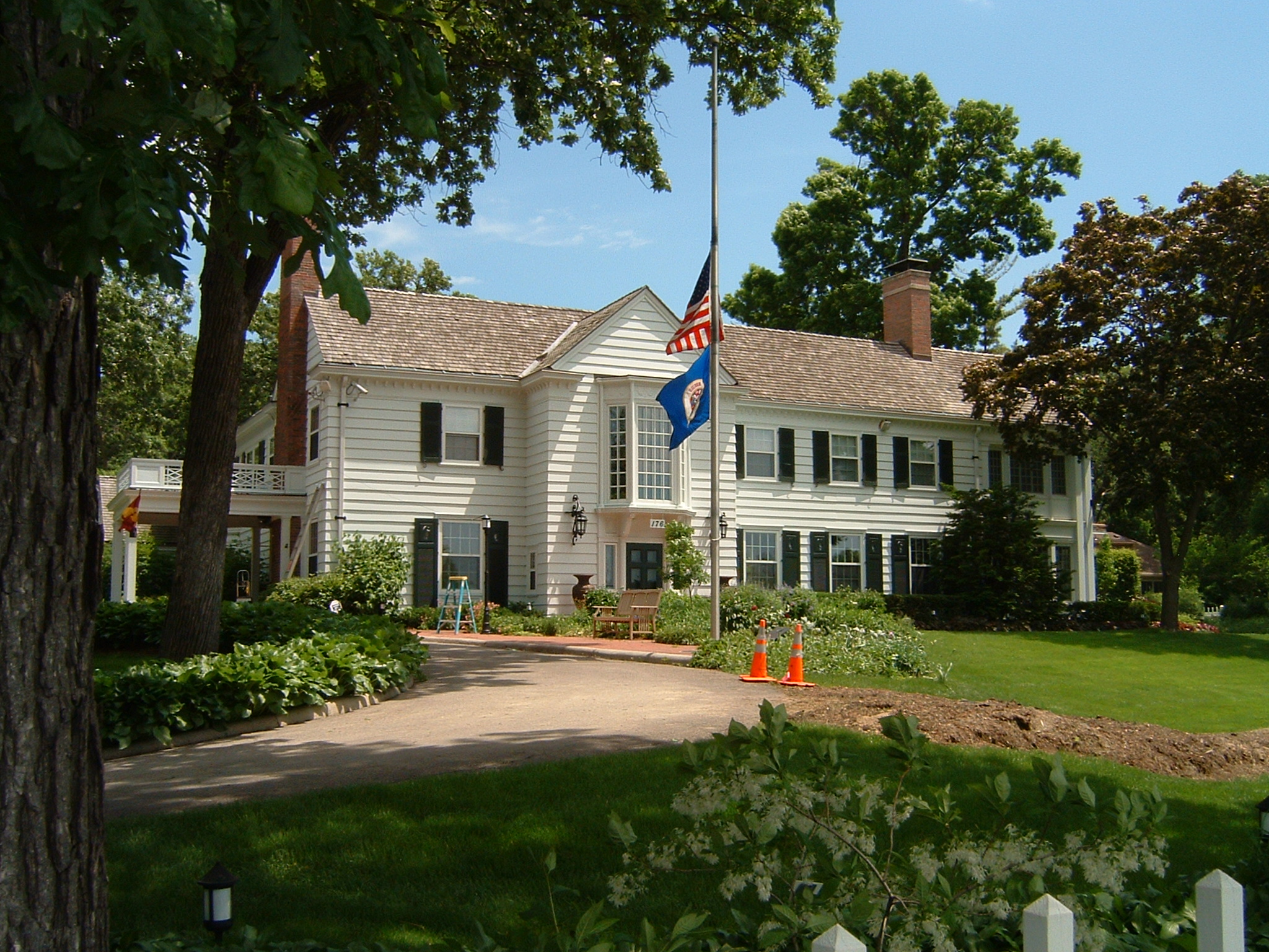 a white house with a flag flying from the front