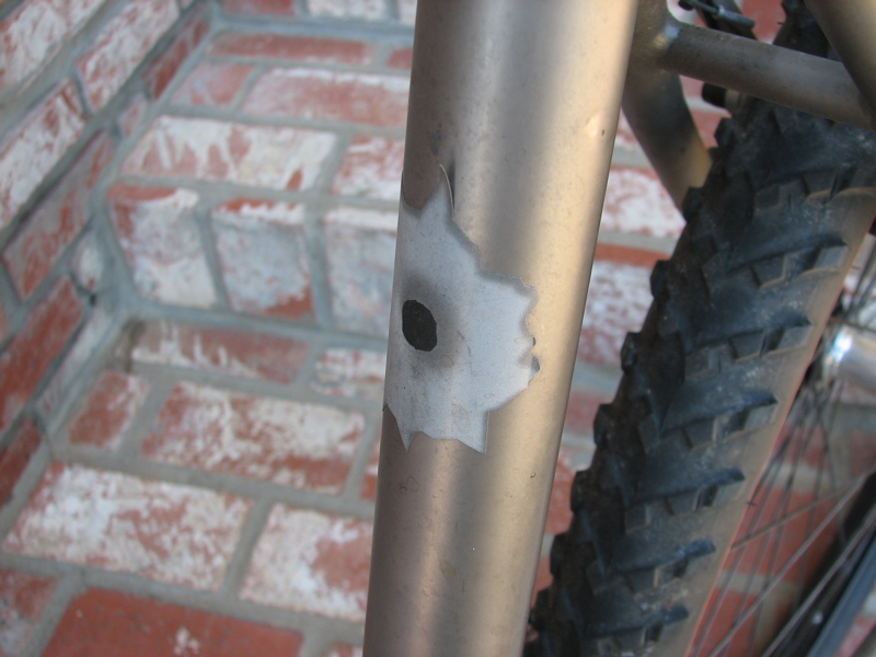 a rusty and dirty bike parked on brick ground