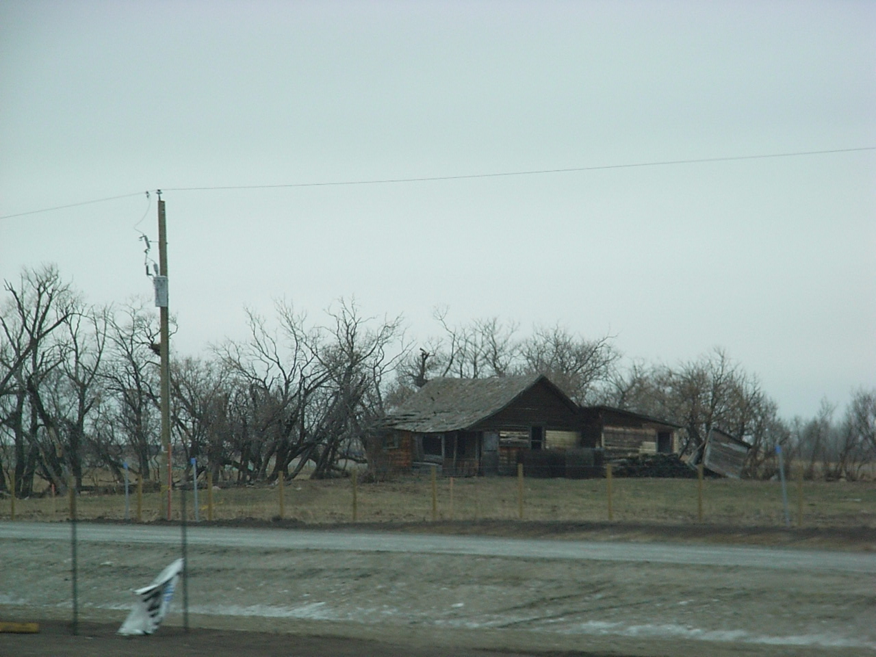 a po of an old barn on the side of the road
