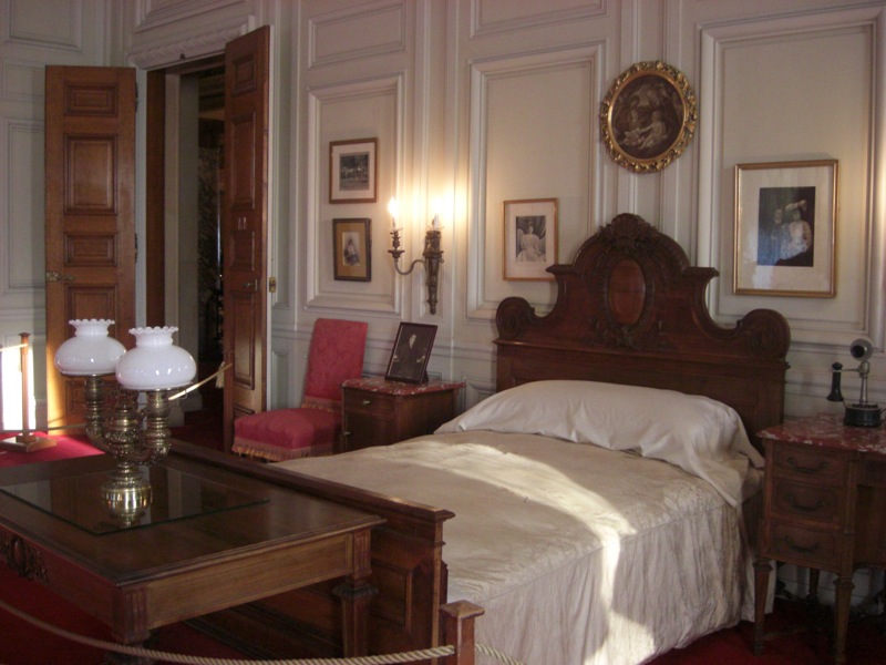 an old style bedroom with some large white walls
