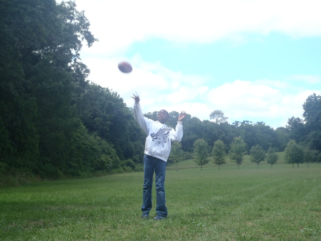 a man in a field with a frisbee