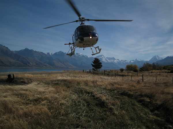 a helicopter is flying over an empty field