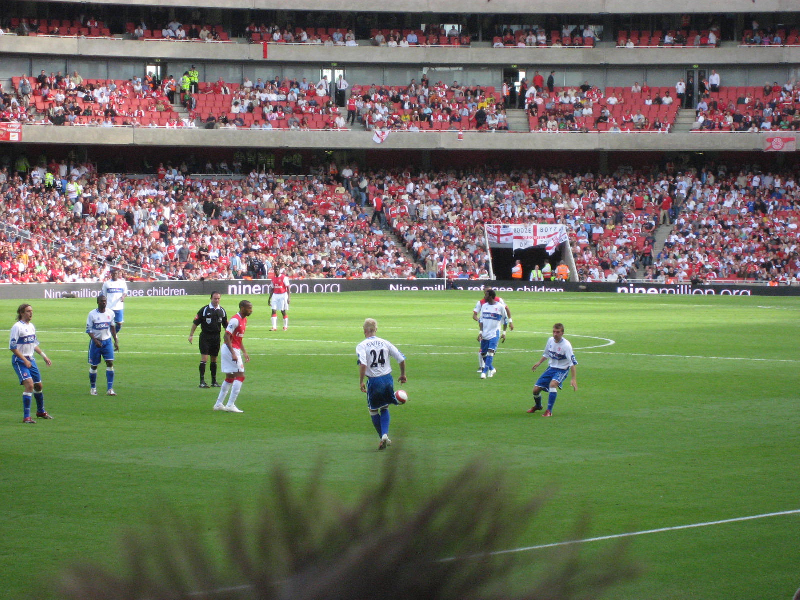 the soccer field is full of fans watching and playing