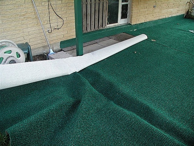 a piece of cloth sits on a porch near the door