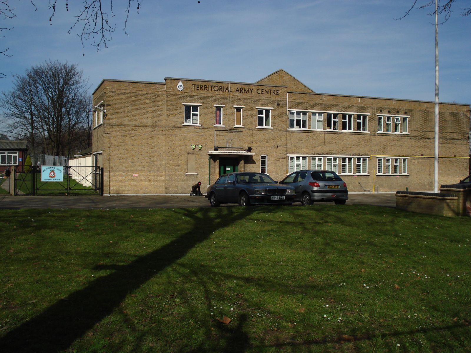 cars parked outside of the front of a brick building