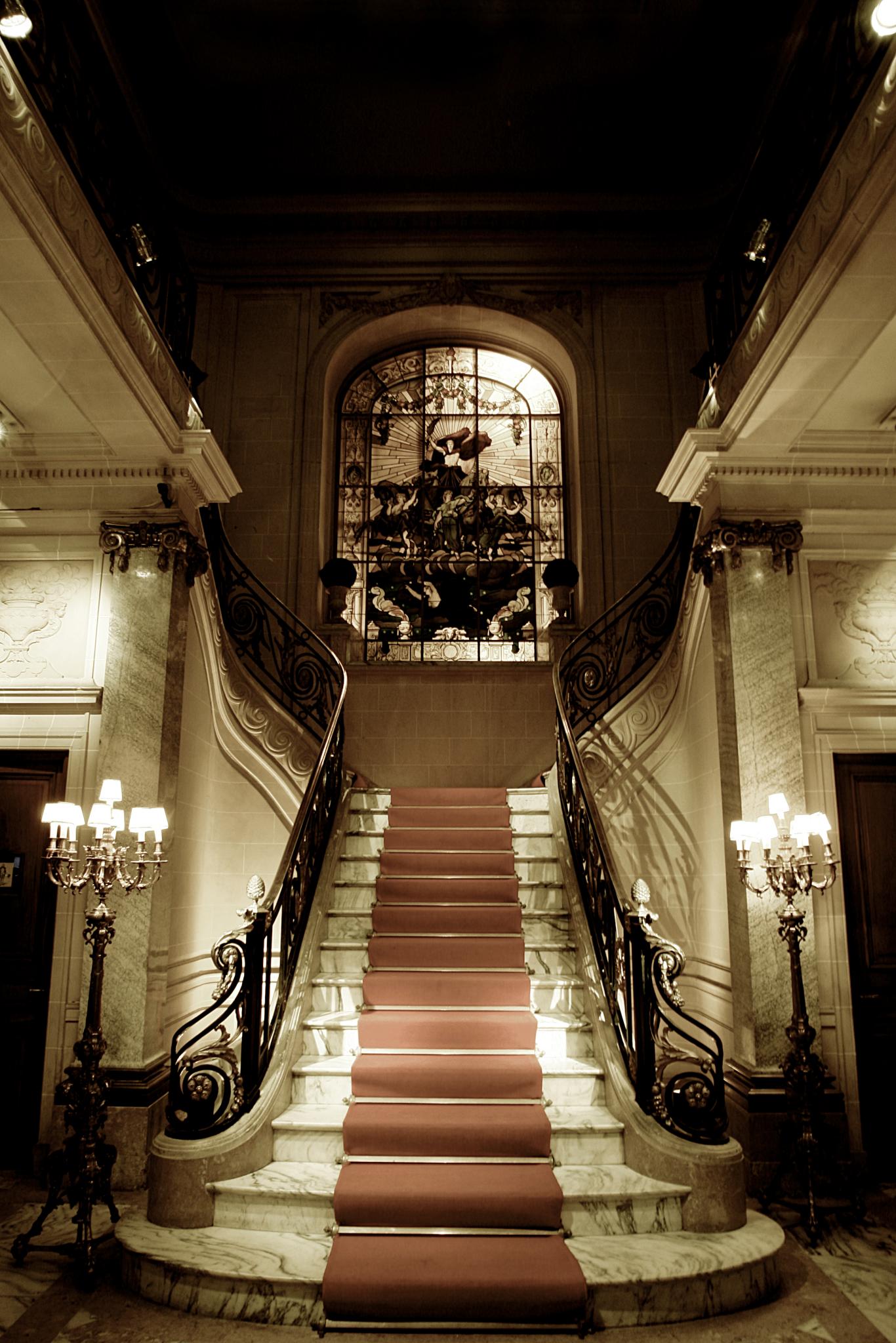 an empty room with several stairs and chandeliers