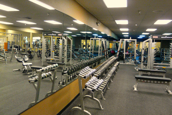 the gym has many exercise equipment on the floor