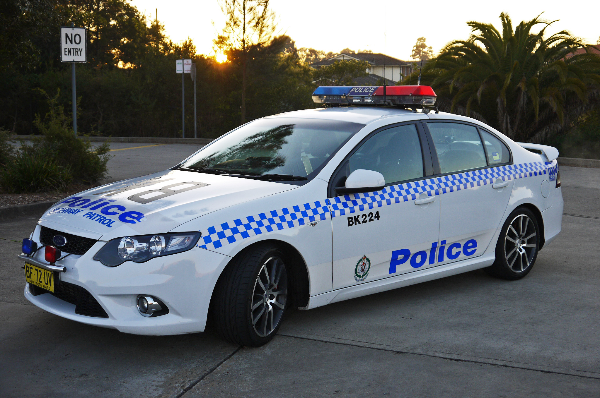 police car parked in a residential area at sunset