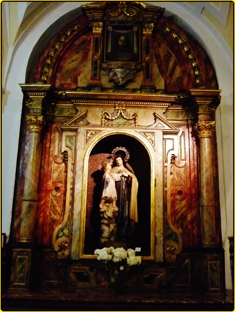 an antique shrine with a statue on it