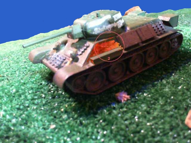 a picture of a toy tank in the green grass