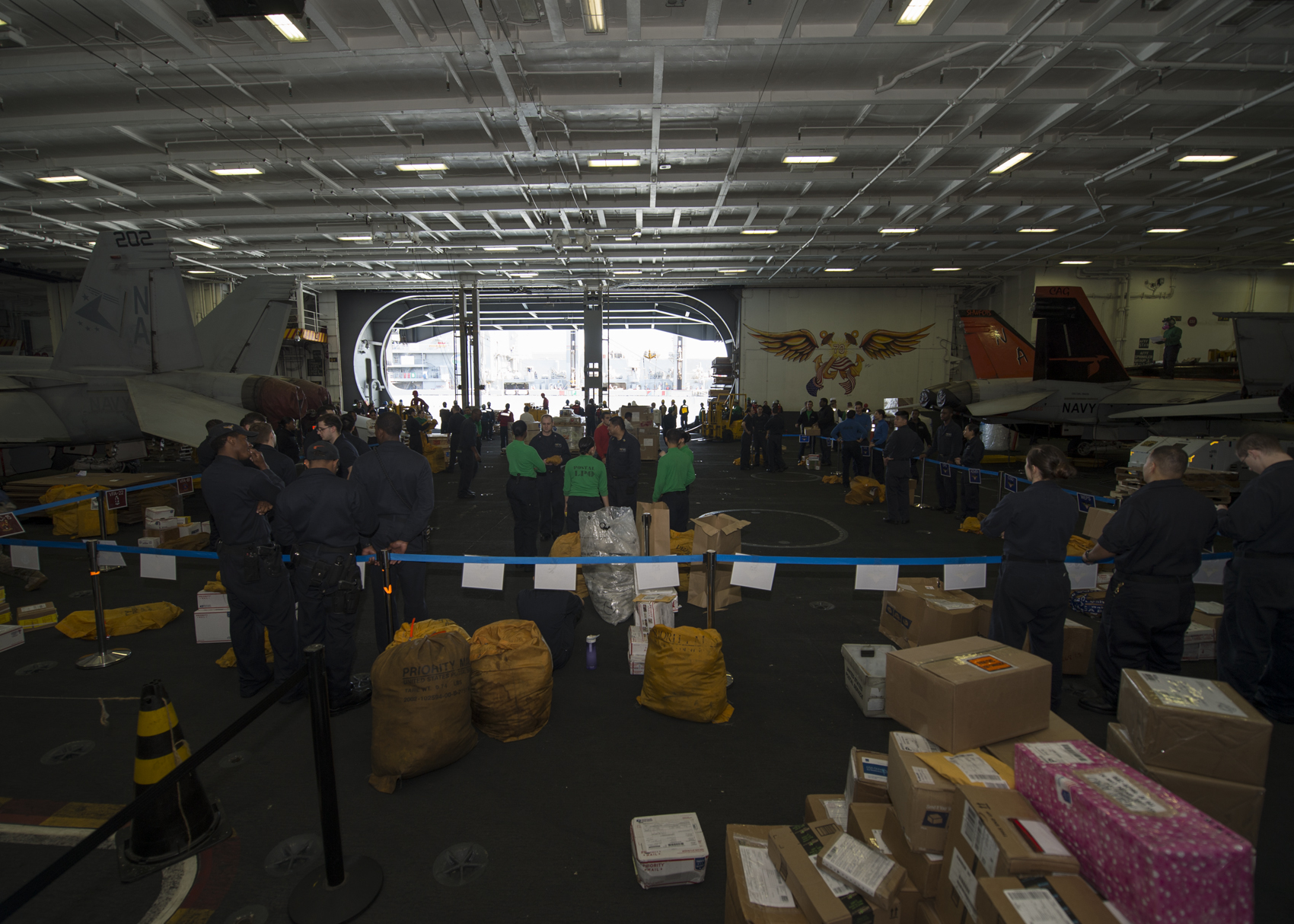 several people standing around boxes with boxes behind them