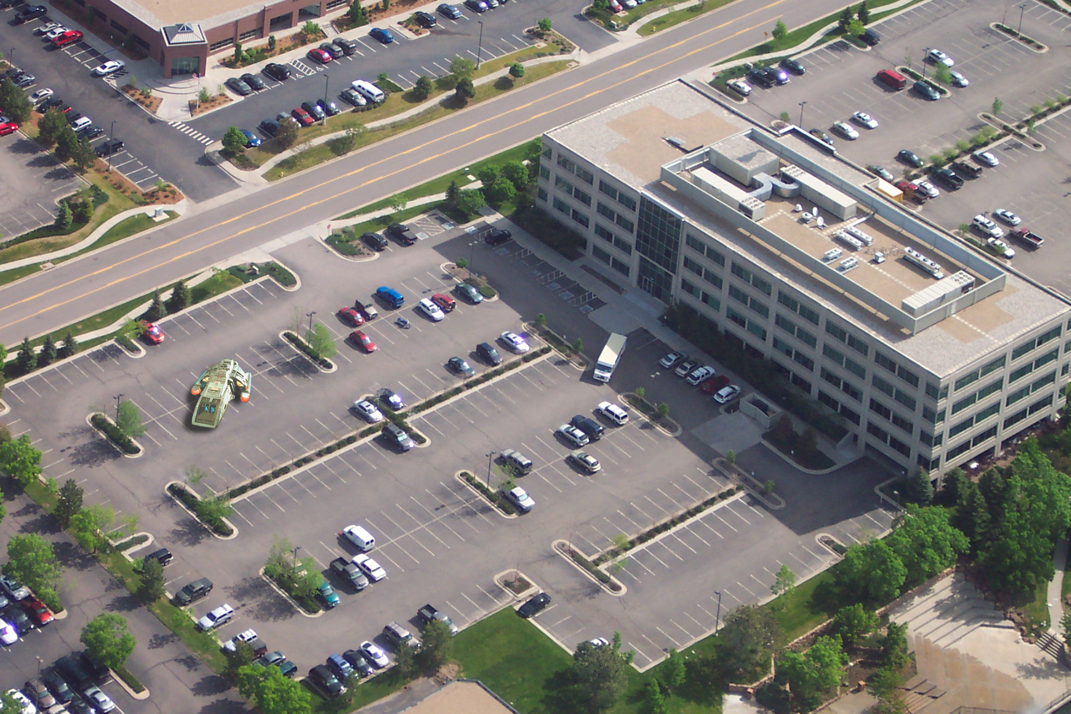 aerial view of an empty parking lot next to a building