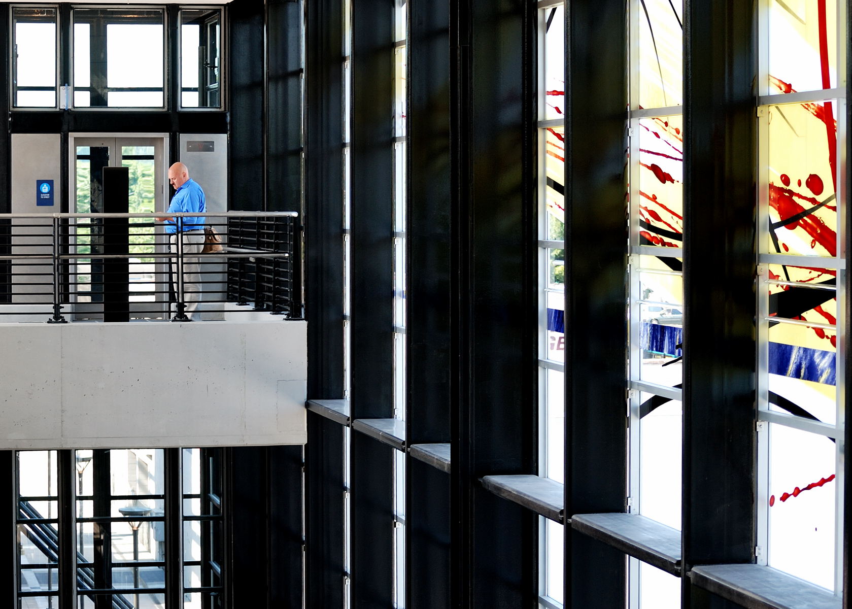 a person walking down a metal balcony