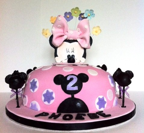 cake decorated with a minnie mouse theme and number two