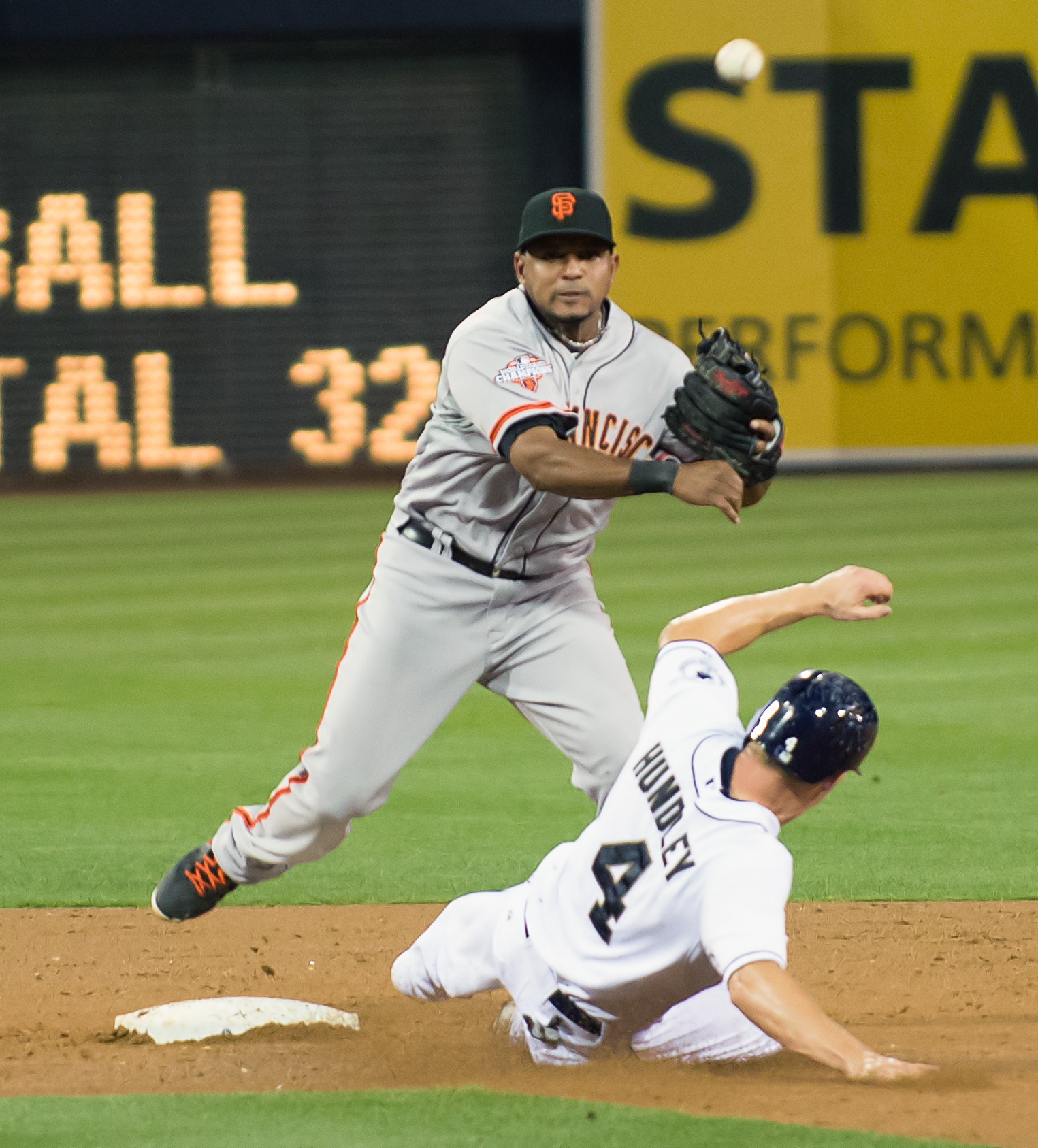 a baseball player is running while trying to get to base