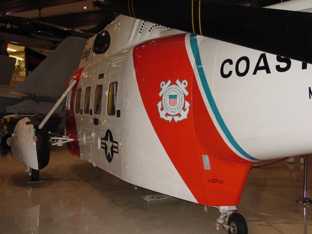 a vintage us coast guard airplane parked in a garage