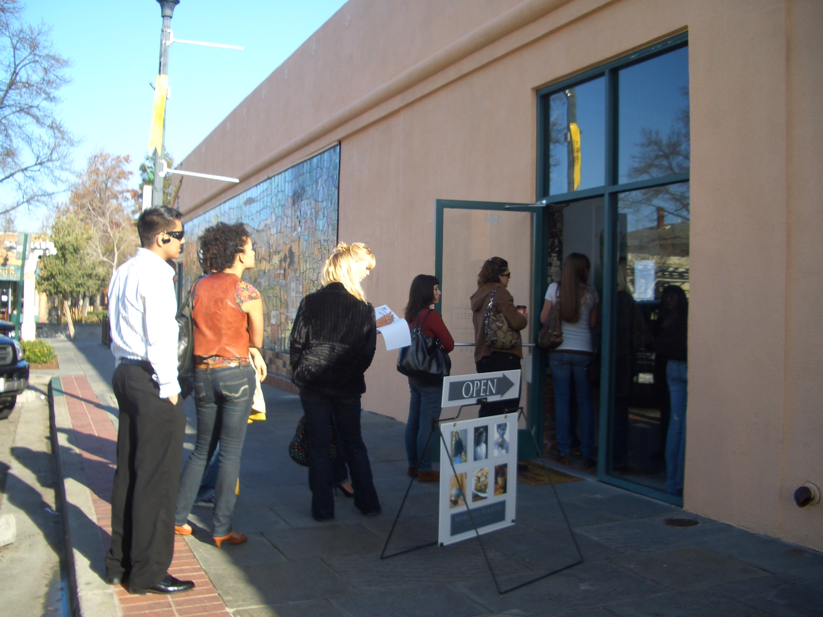 a group of people outside of a dogs restaurant