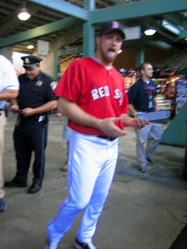 a man in red jersey walking towards the crowd