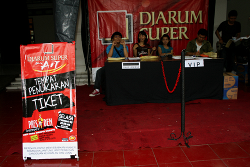 a table with a red carpet and a red sign