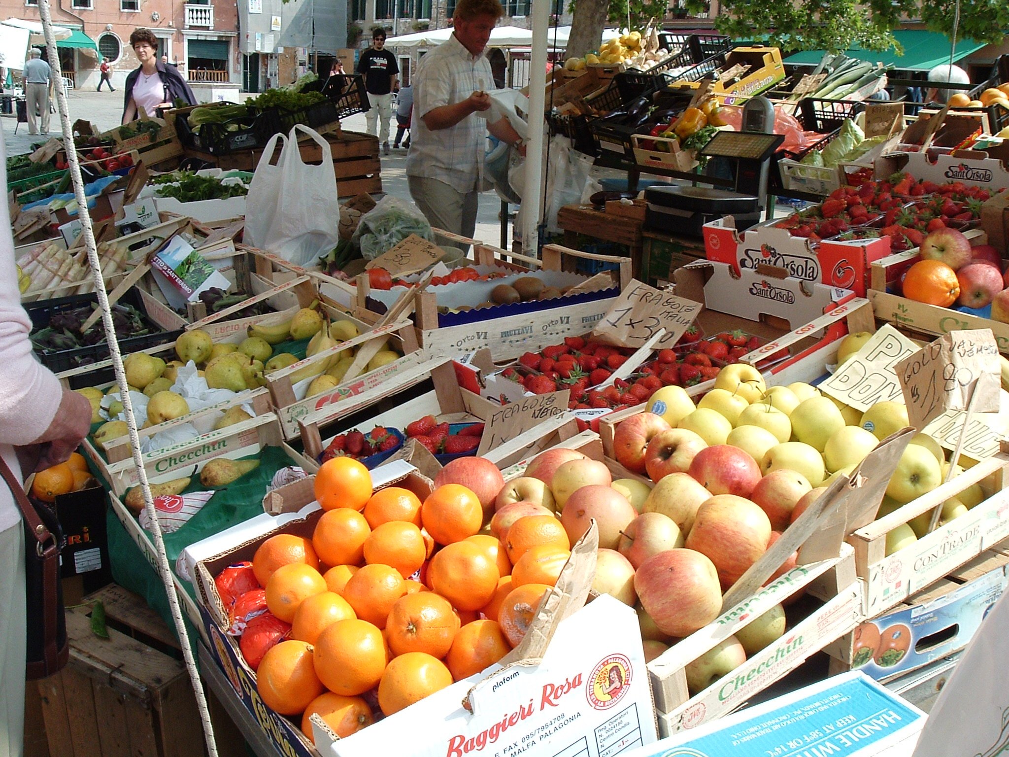 an open air farmers market filled with fresh fruits