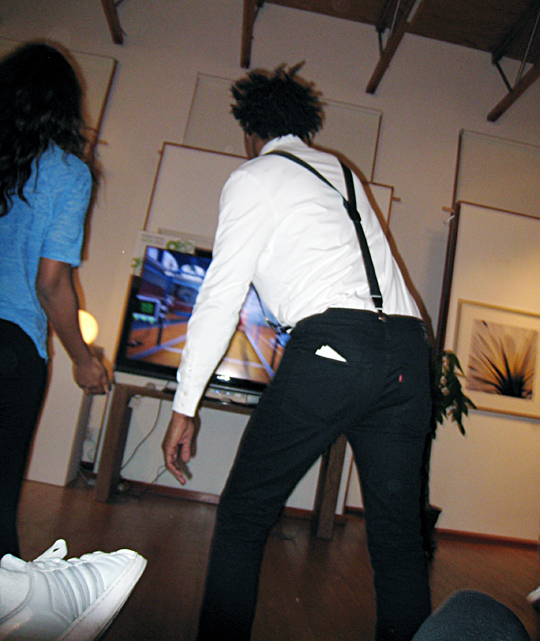 a man in a white shirt is playing a game with the wii